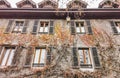 The faÃÂ§ade of an old tenement house with colorful climbing plants Royalty Free Stock Photo