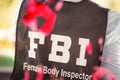 FBI woman. Focus is on background. Print of hand