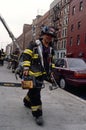 FDNY firefighter carrying tools and equipment in New York City, USA