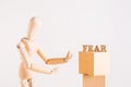 Fear concept wooden man and word fear on light background Royalty Free Stock Photo