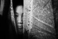 Fear girl hiding behind curtain with shadow edge Royalty Free Stock Photo