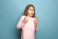 The fear. Teen girl on a blue background. Facial expressions and people emotions concept Royalty Free Stock Photo