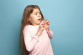 The fear. Teen girl on a blue background. Facial expressions and people emotions concept Royalty Free Stock Photo