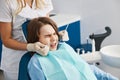 Fearful child is squinting during dental procedure Royalty Free Stock Photo