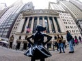 Fearless Girl Statue looking at New York Stock Exchange. Royalty Free Stock Photo