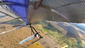 Fearless hang glider pilot fly high above terrain