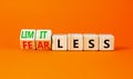 Fearless and limitless symbol. Concept word Fearless and limitless on wooden cubes. Beautiful orange table orange background.