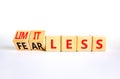 Fearless and limitless symbol. Concept word Fearless and limitless on wooden cubes. Beautiful white table white background.