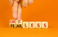 Fearless and limitless symbol. Concept word Fearless and limitless on wooden cubes. Businessman hand. Beautiful orange table Royalty Free Stock Photo