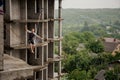 Fearless young man balancing on a slackline against building