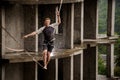 Fearless young man balancing on a slackline