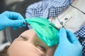 Fearless young patient lies in the dentist chair