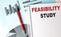 FEASIBILITY STUDY text on notebook on chart background