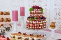 A feast of cakes served on the buffet.sweet desserts with berries and fruit served on the buffet.Fruit Wedding Cake.