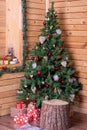 A beautifully decorated corner of a wooden house with Christmas decorated tree and gifts Royalty Free Stock Photo