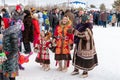 Feast of reindeer herders and fishermans. A woman with a child in national costumes