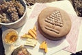 Feast in a vineyard with ritual bread, cheese and white wine. Royalty Free Stock Photo