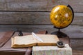 Feather on book beside inkwell. Royalty Free Stock Photo