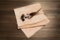 Feather, fountain pen, inkwell and vintage parchment with ink stains on wooden table, top view Royalty Free Stock Photo