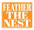 FEATHER THE NEST, text on orange stamp sign Royalty Free Stock Photo