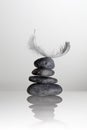 Feather over zen stones Royalty Free Stock Photo