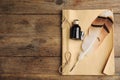 Feather pen, bottle of ink and notebook on wooden table, top view. Space for text Royalty Free Stock Photo