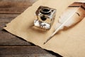 Feather pen, inkwell and blank parchment