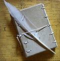 Feather quill pen with old handmade leather notebook closeup Royalty Free Stock Photo