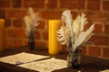 Feather quill pens candle and old paper on wooden desk. Vintage. Royalty Free Stock Photo