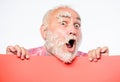 Feathers madness. Man bearded mature emotional face with stuck white feathers close up. Funny pensioner going crazy Royalty Free Stock Photo