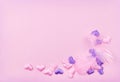 Feathers and pink and purple satin hearts in a cornar arrangement on paper texture for Valentine Day Royalty Free Stock Photo