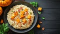 Featured is a shot of a pumpkin and bacon risotto served on a dark wooden plate. Royalty Free Stock Photo