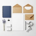 Features a blue spiral-bound notebook, brown kraft envelopes, and white statio Royalty Free Stock Photo