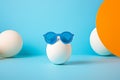 Summer Sphere White Ball wearing Blue Sunglasses on Light Blue Background Studio Shot Royalty Free Stock Photo