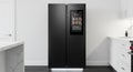 Featuring a black, side-by-side smart refrigerator with a touchscreen Royalty Free Stock Photo