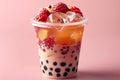 Featuring a boba tea with red fruit and ice cubes in a plastic cup isolated on a pink background, in a front view. fresh bubb Royalty Free Stock Photo