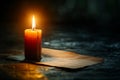 Featuring a  single candle burning in the darkness, casting its light on an empty paper letterhead. the simplicity of the scene i Royalty Free Stock Photo