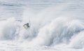 Amazing shot of a professional surfer surfing in the sea with big waves in summer