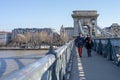 Feb 8, 2020 - Budapest, Hungary: Tourists on Szechenyi chain bridge in the morning Royalty Free Stock Photo