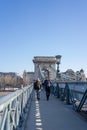 Feb 8, 2020 - Budapest, Hungary: Tourists on Szechenyi chain bridge in the morning Royalty Free Stock Photo