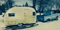 FEB 25, 2019 - COLORADO-UTAH - USA - Vintage pickup truck and yellow trailer in snow - Colorado/Utah area