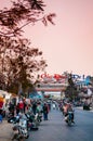 Busy evening with motorcycle traffic at night market in Dalat city - Vietnam
