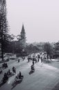 Motorcycle traffic in evening at Da Lat Cathedral with Purple orchid tree