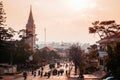 Motorcycle traffic in evening at Da Lat Cathedral with Purple orchid tree