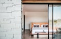 White contemporary hotel style bedroom with gray color stone wall exterior decoration