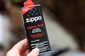 Close up of a Zippo Brand Lighter Fluid, isolated. Hand holding the product