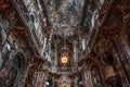 Feb 2, 2020 - Munich, Germany: Ultrawide upward view of ceiling fresco altar facade in Baroque style church Asamkirche Royalty Free Stock Photo