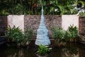 Bronze pagoda sculpture in water pond, Thai garden landscape