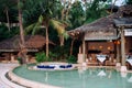 Vacation Relaxation sunken lounge seat in infinity pool tropical