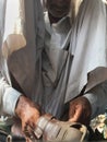 Skilled hands using needal & working on roadside shoe repairer in Kalyan